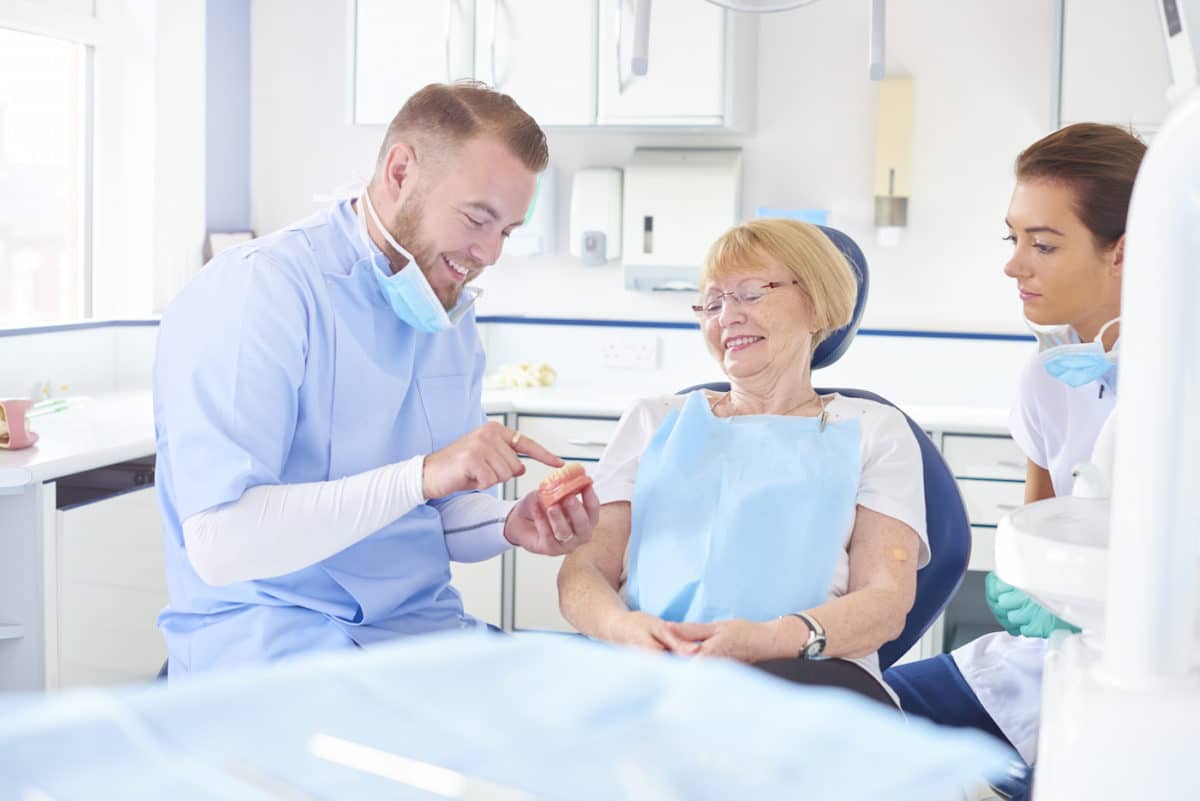 A Dentist Talking to a Patient About Affordable Dentures